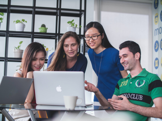 Group of young people looking at computer screen